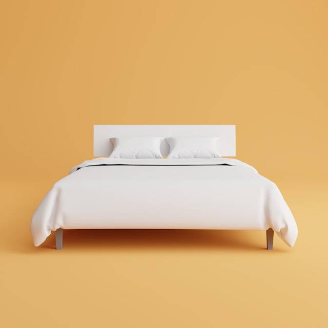 Imagen de una cama sobre un fondo naranja